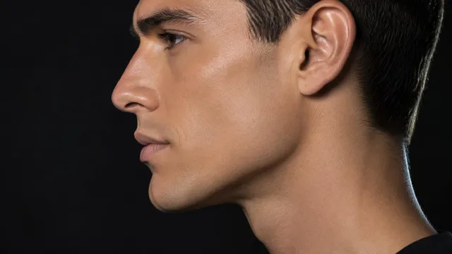 AI-generated illustration: a man's face in strict side profile, with a sharply defined jawline running from the chin back to a clearly visible jaw corner below the ear.